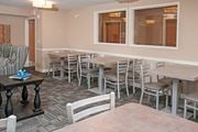 Carver apartment for rent - Multiple Small Tables with Chairs for Dining in Community Room in Carver, MN Apartments