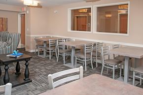Carver apartment for rent - Multiple Small Tables with Chairs for Dining in Community Room in Carver, MN Apartments