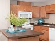 Carver apartment for rent - Carver Crossing Apartment Kitchen with Medium Wood Cabinetry and Large Center Island