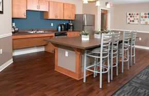 Lakeville apartment for rent - a kitchen with a bar and stools and a table with chairs