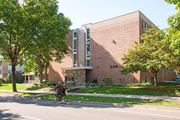 Minneapolis apartment for rent - a person riding a bike in front of a brick building