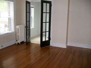 Minneapolis apartment for rent - a room with a wood floor and a black door