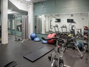 Minneapolis apartment for rent - A gym with a variety of equipment including a treadmill, exercise balls, and weight machines.at Gurley Lofts, Minnesota