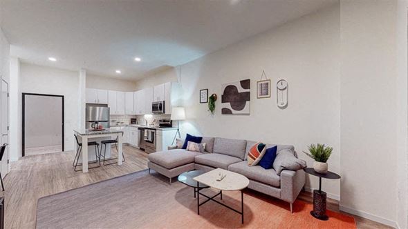 Minneapolis apartment for rent - A modern living room with a grey sofa and a coffee table at The Bessemer at Seward Commons Apartments, Minneapolis, 55404