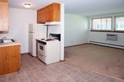 St Anthony apartment for rent - an empty kitchen with a stove refrigerator and sink