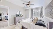 Mahtomedi apartment for rent - A bedroom with a large bed and a ceiling fan.