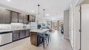 Mahtomedi apartment for rent - A modern kitchen with dark wood cabinets and white appliances.