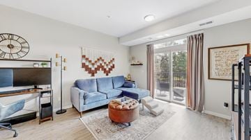 Mahtomedi apartment for rent - A living room with a blue couch and a wooden coffee table.