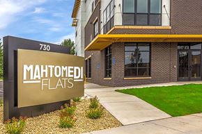 Mahtomedi apartment for rent - a sidewalk in front of a building with a sign that reads maintained flats