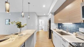 Minneapolis apartment for rent - A modern kitchen with a long counter and a sink.