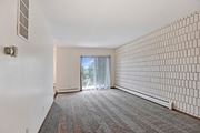 Bloomington apartment for rent - an empty living room with white walls and a sliding glass door