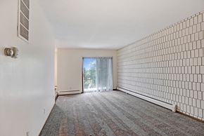 Bloomington apartment for rent - an empty living room with white walls and a sliding glass door