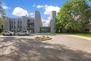 Bloomington apartment for rent - a view of the front of a building with cars parked in front of it