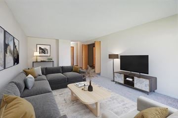Bloomington apartment for rent - a living room with a gray couch and a television