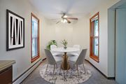 Bloomington apartment for rent - a dining room with a table and chairs and a ceiling fan