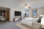 Bloomington apartment for rent - a bedroom with a large bed and a ceiling fan