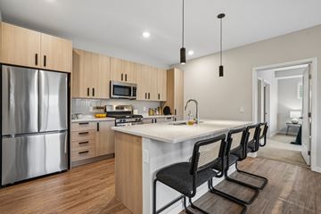 Long Lake apartment for rent - A modern kitchen with a refrigerator, microwave, oven, and sink.
