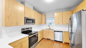 Minnetonka townhouse for rent - A kitchen with wooden cabinets and stainless steel appliances.
