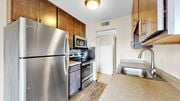New Hope apartment for rent - A kitchen with a stainless steel refrigerator and a microwave above the stove.