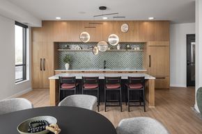 Victoria apartment for rent - A modern kitchen with a dining table set for four.