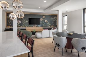 Victoria apartment for rent - A modern dining room with a black table and chairs.