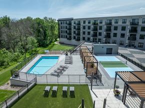 Victoria apartment for rent - A large outdoor pool area with sun loungers and a wooden deck.