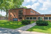 St Anthony apartment for rent - a brick building with a sign in front of it