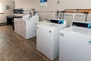 St Anthony apartment for rent - a row of washers and dryers sit in a room