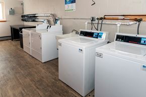 St Anthony apartment for rent - a row of washers and dryers sit in a room