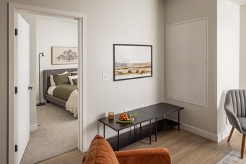 Bloomington apartment for rent - A living room with a bed, a couch, a chair, and a painting on the wall.
