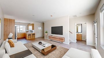 East Bethel townhouse for rent - A modern living room with a white couch and a wooden coffee table.