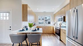 East Bethel townhouse for rent - A modern kitchen with a dining table and chairs.