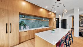 Victoria apartment for rent - A kitchen with wooden cabinets and a white countertop.
