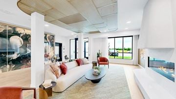 Victoria apartment for rent - A modern living room with a white couch and a fireplace.