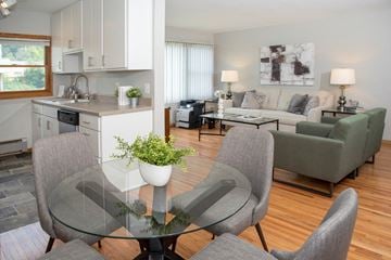 Saint Paul apartment for rent - a living room and kitchen with a glass table and chairs