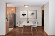Saint Paul apartment for rent - a dining room with a table and chairs and a refrigerator