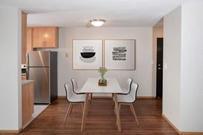 Saint Paul apartment for rent - a dining room with a table and chairs and a refrigerator