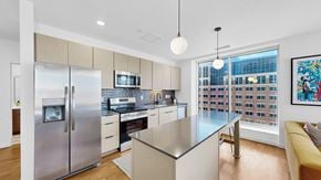 St. Paul apartment for rent - A modern kitchen with a stainless steel refrigerator and a large island.