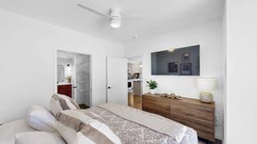 St. Paul apartment for rent - A bedroom with a bed, dresser, and a ceiling fan.