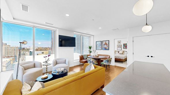 St. Paul apartment for rent - A living room with a yellow couch and a flat screen TV.
