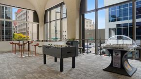 St. Paul apartment for rent - A foosball table is in the middle of a room with a pool table in the background.