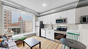 St. Paul apartment for rent - A kitchen with white cabinets and a black countertop.