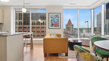 St. Paul apartment for rent - A living room with a yellow couch and a painting on the wall.