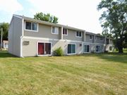 Anoka apartment for rent - A long building with a red door in the middle.