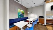 Saint Paul apartment for rent - A modern dining area with a white table and blue chairs.