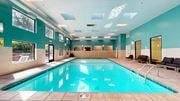 Saint Paul apartment for rent - A large indoor swimming pool with a sunny view outside.
