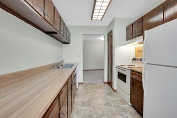 Bloomington apartment for rent - a kitchen with a wooden counter top and white appliances