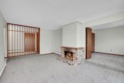 Bloomington apartment for rent - a living room with a fireplace and a wooden door