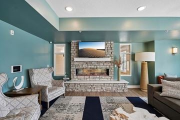 White Bear Lake apartment for rent - A living room with a fireplace and a painting on the wall.