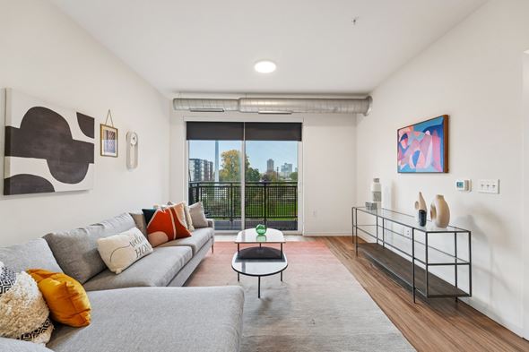Minneapolis apartment for rent - A living room with a grey couch and a coffee table.
